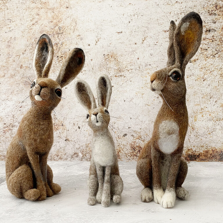 three needle-felted hares