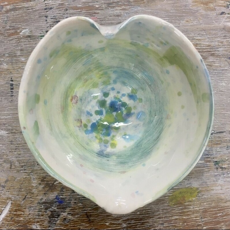 a photo of a heart shaped bowl made out of clay fired and glazed.