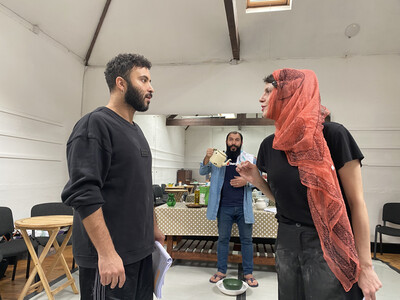 A man and a woman wearing a vibrant red head scarf