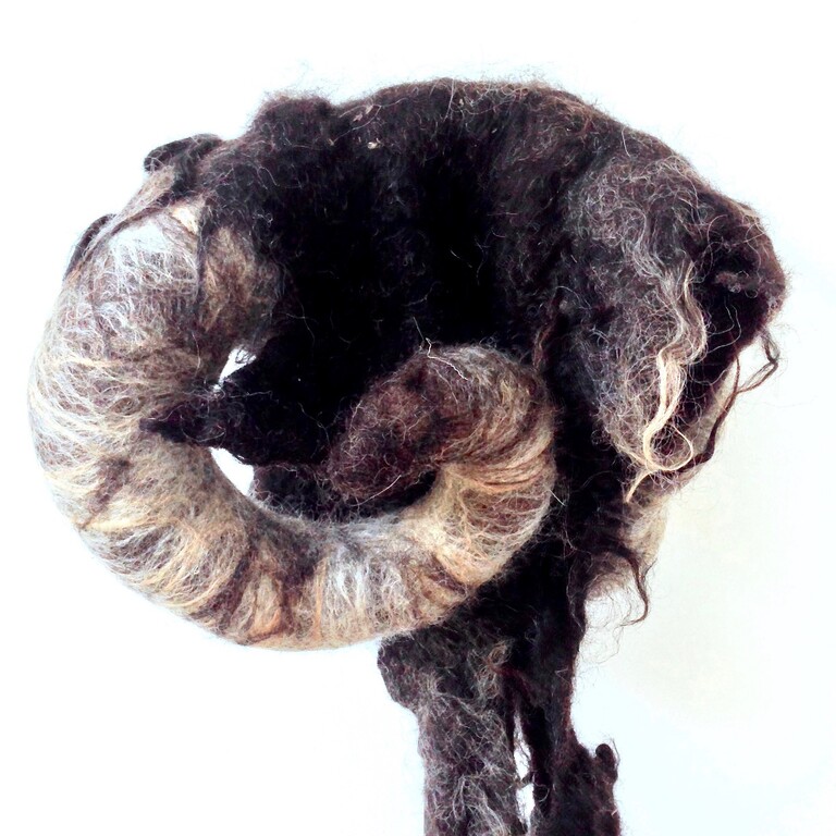 A felted hat in the shape of a ram's head with horns