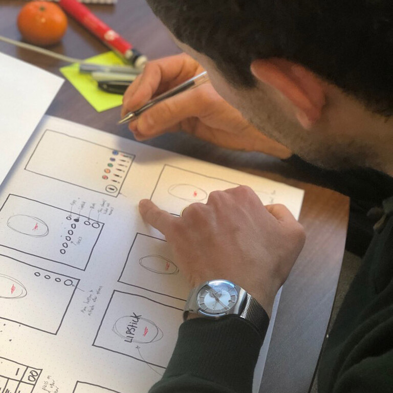 A man draws into his sketchbook