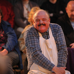 Actor Mick grinning and shrugging