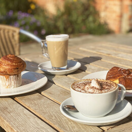 Assortment of coffee and pastries on a table outside the Riverside Cafe