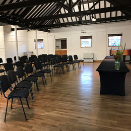 The barley room in farnham maltings set up for a meeting with chairs