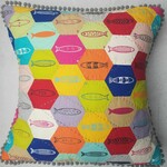 Multi coloured hexagonal patchwork cushion with images of fish
