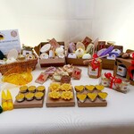 A table display of Bee products with Honey, wax candles and beeswax wraps