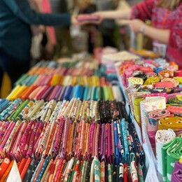 A display of fabrics and people browsing