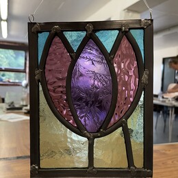 A stained glass leaf design from a stained glass workshop.