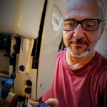 Tibor Eperjessy feeding fabric through a sewing machine