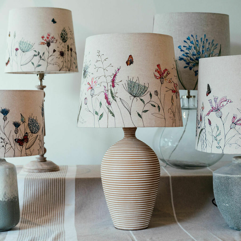 A selection of handmade lampshades with botanical flowers stitched on them