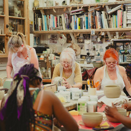 group of people doing a pottery class