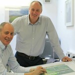 Two men in a studio smiling