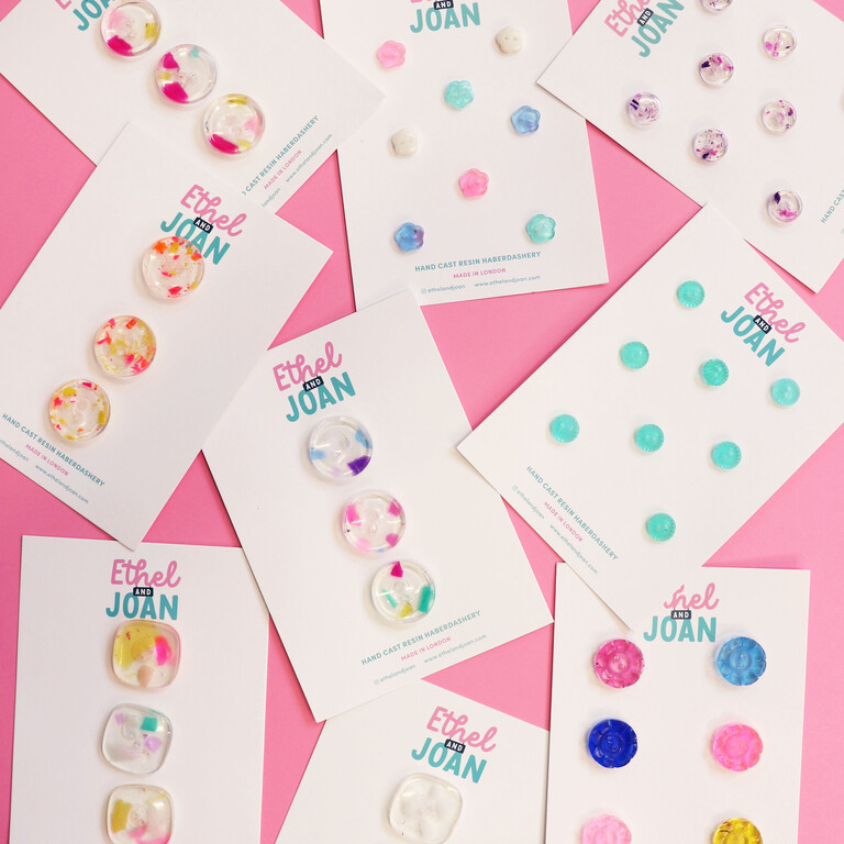 9 button cards with bright plastic buttons on on a pink background