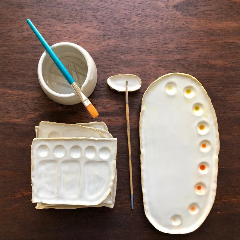 A ceramic handmade paint pallet ideal fur using with watercolours and a ceramic water pot to use with a watercolour paint brush