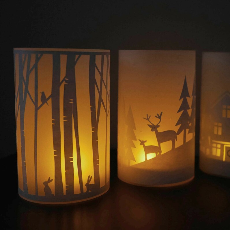 A photo of paper lanterns that show designs created from paper cutting