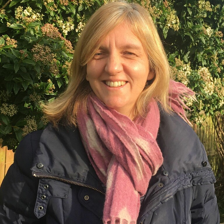 Picture of Flora Gare smiling in a garden