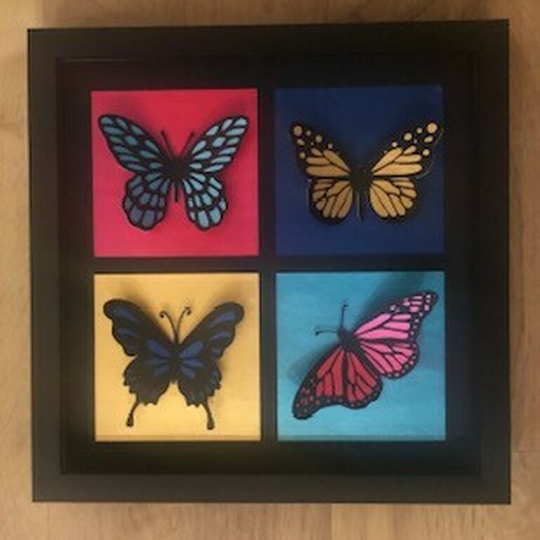 A 3D paper collage of four butterflies in a frame by Sue Woodger