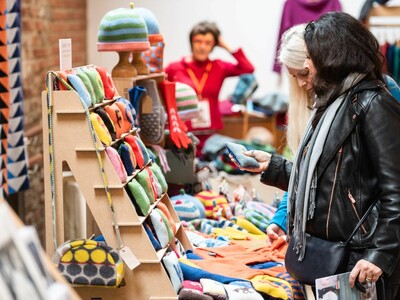 Two woman browse a craft stall at the festival of crafts