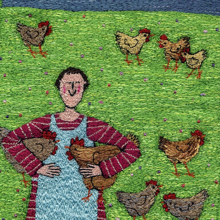 A machine embroidered picture of a woman holding chickens
