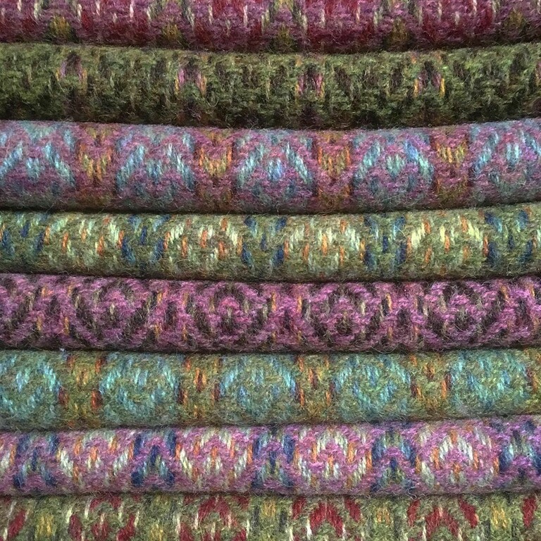 A pile of folded handwoven textiles