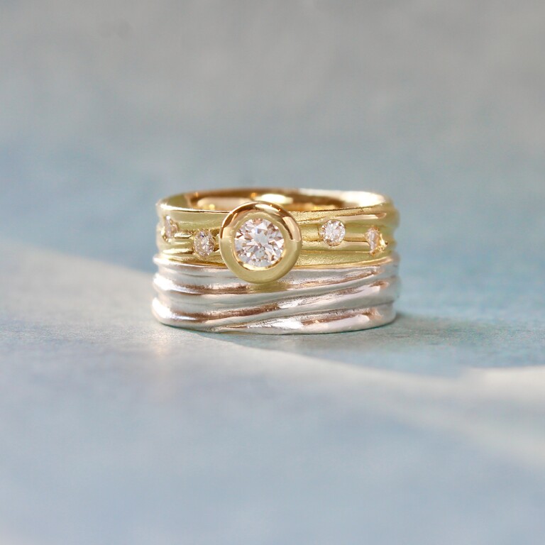 A gold ring stacked on a silver ring