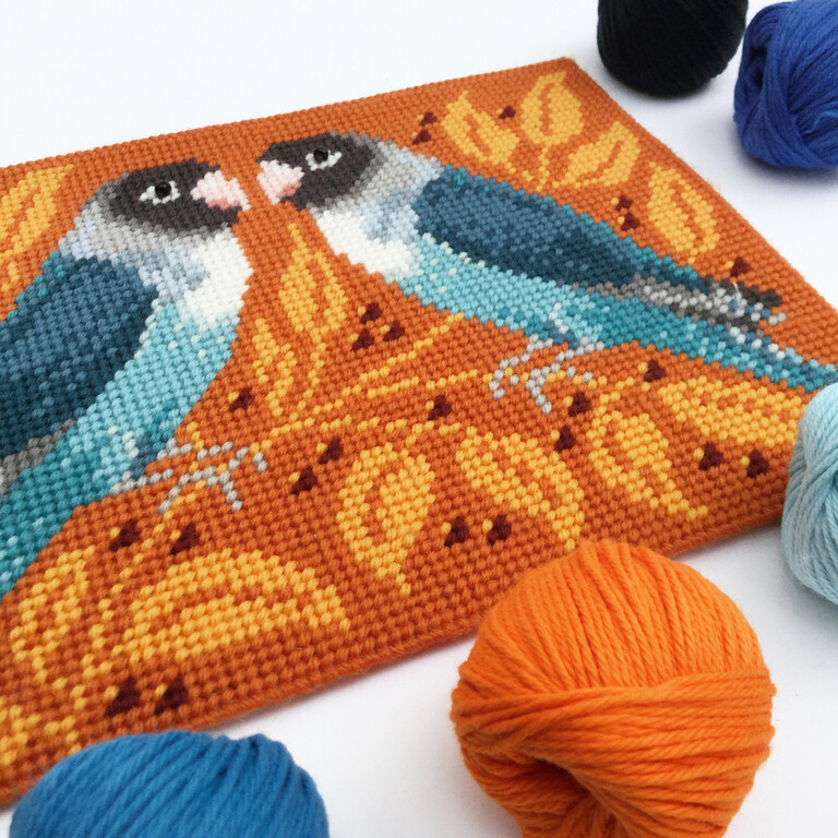 tapestry of two blue birds looking at each other on a rust leaf back ground
