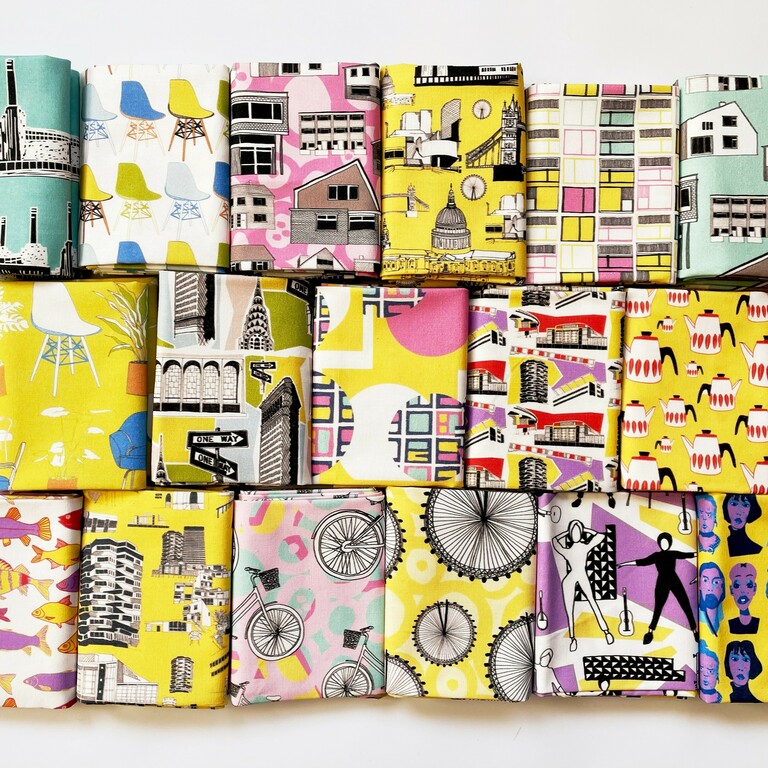 Three rows of brightly coloured patterned fabric folded in stacks