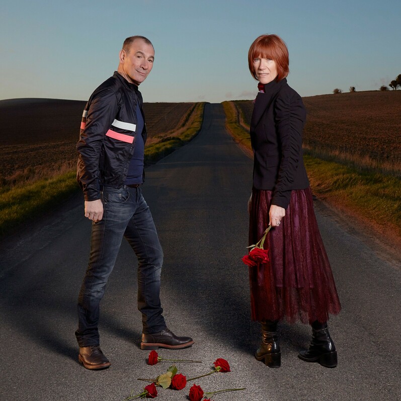 Promotional image for Kiki Dee and Carmelo Tour showing both standing in a road