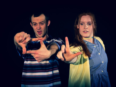 Characters Bobby and Amy making gestures with their arms outstretchced