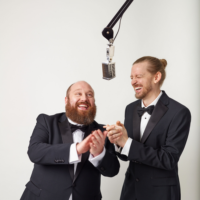 Jonny and the Baptists smile either side of a microphone