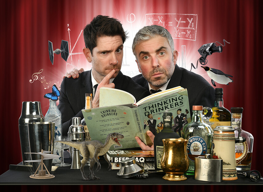 Promotion shot of Thinking Drinkers, reading a book and surrounded by different types of alcohol