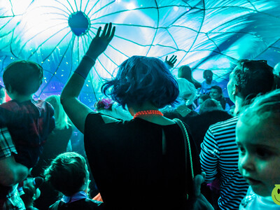 A Group of adults and children dance at the Big Fish Little fish Rave