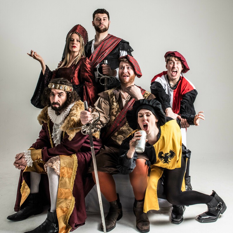 Performers from Sh*t-faced Shakespeare pose in costumes, ready for their performance of Macbeth.