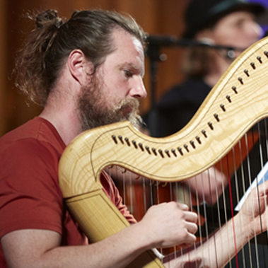 Gareth Wilkins playing the harp