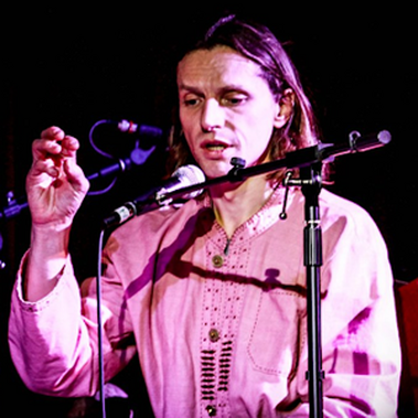 Performer Kieron Chissik talks into a microphone