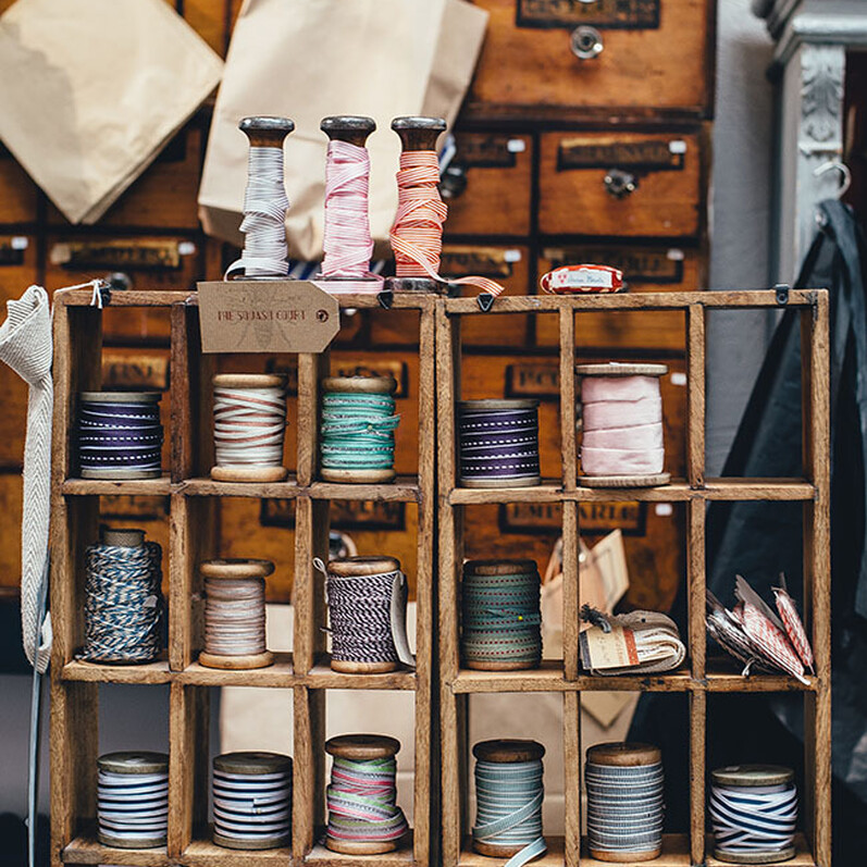 A haberdashery set up with reels of ribbon