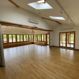 A large well lit studio room with a wooden floor inside the Garden gallery