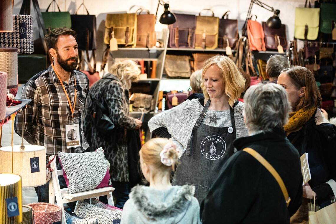 A group of people looking round a craft stall at the festival of craft