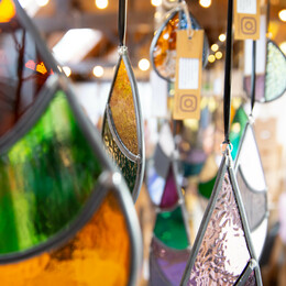 A close up view of a number of mosaic hanging glass decorations