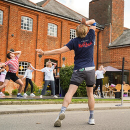 A group dancing outside the front of farnham maltings