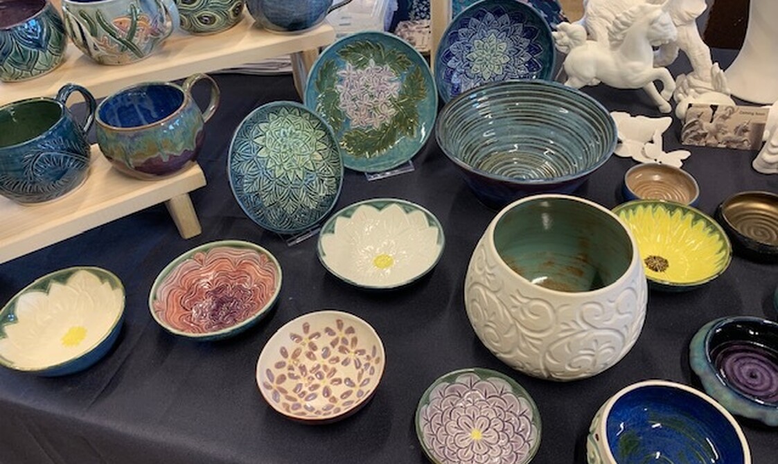 Market stall with decorated bowls and assorted pottery