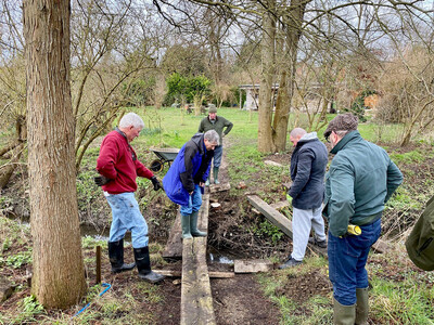 Group of men building a bridge