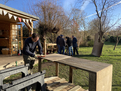 Member of Men in Sheds group working on wooden panel